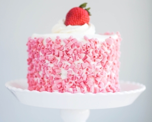 Strawberry cake with white cream on wooden background